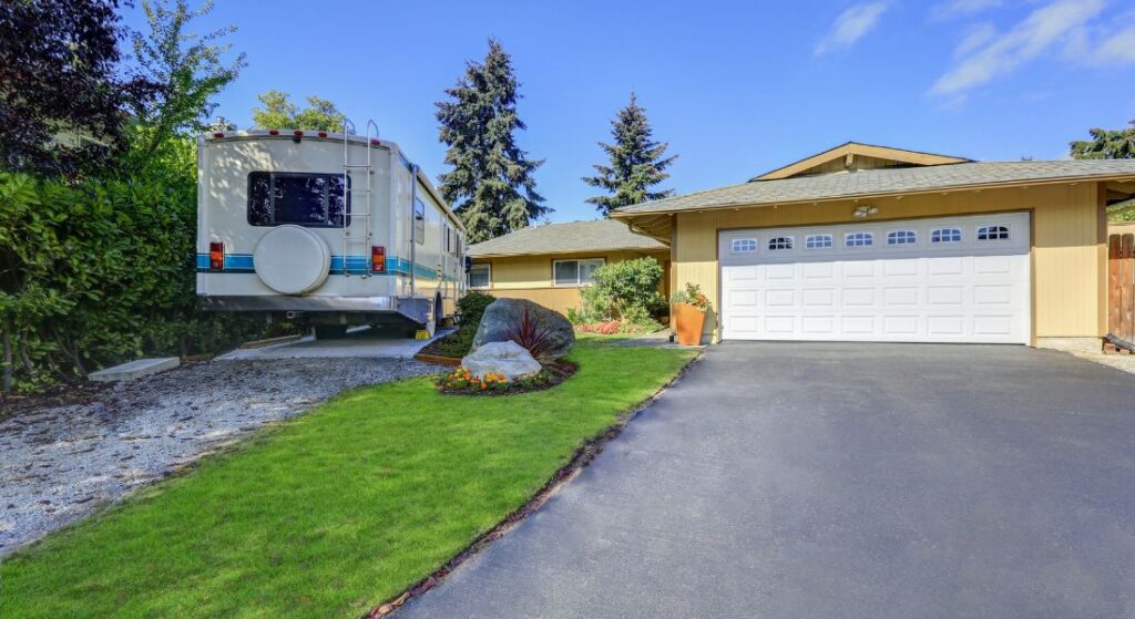 One level home with a motorhome parked in front.