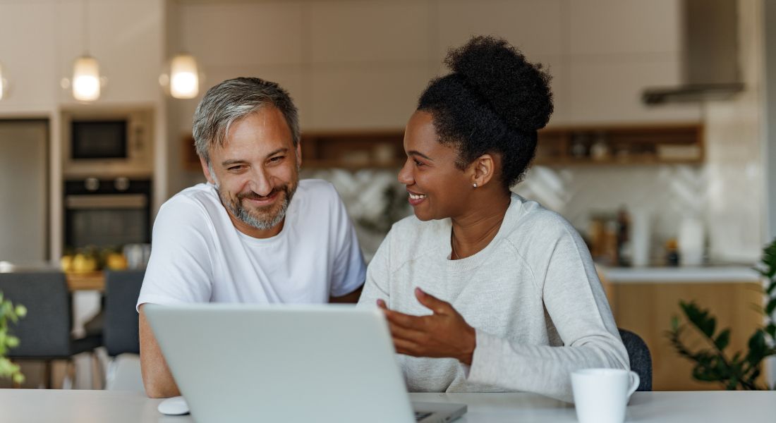 Couple in front of a laptop.